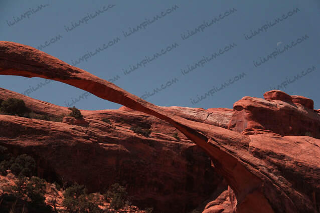 Landscape arch in Arches national park and the moon